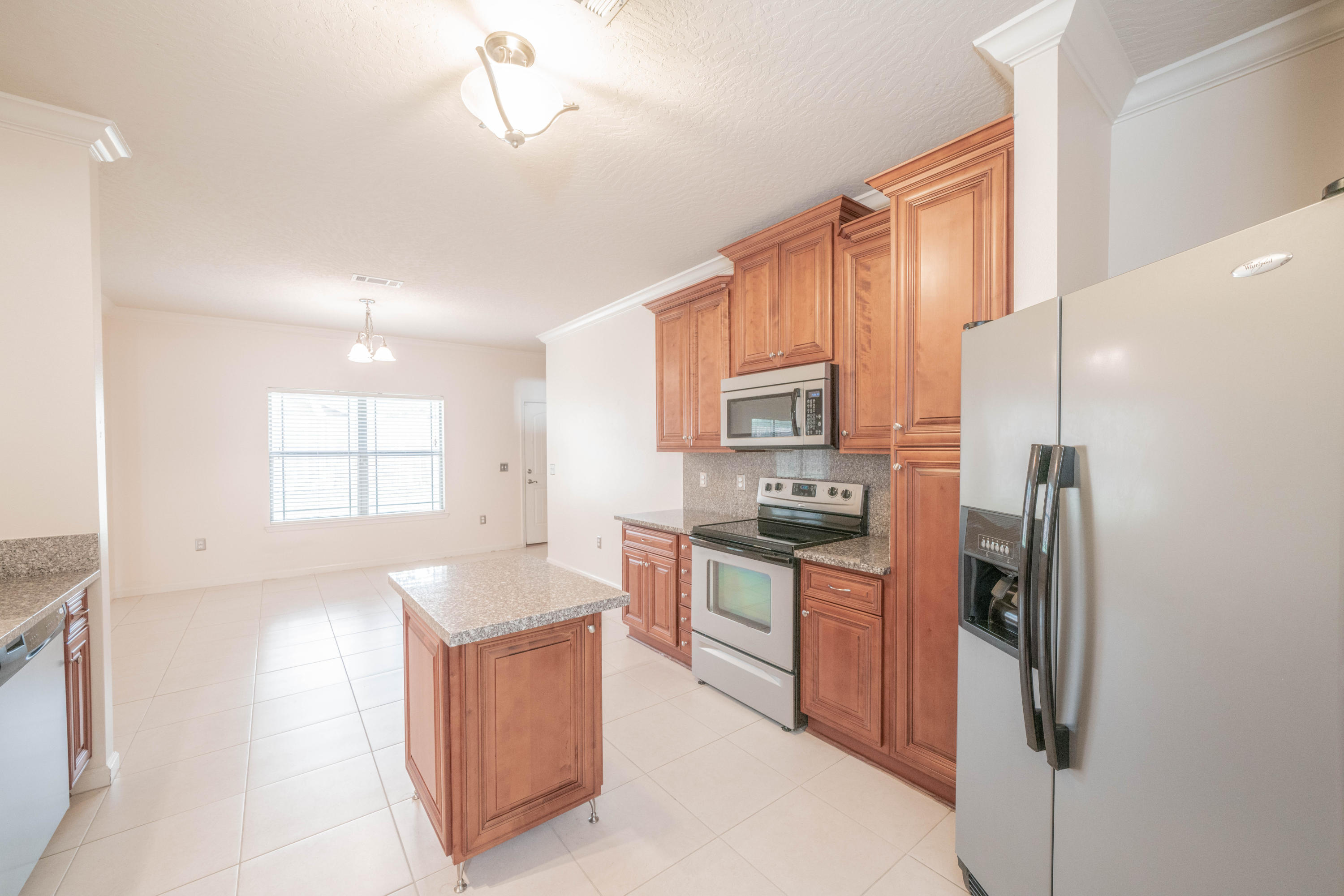 4582 Hermosa Road Crestview, FL 32539 - Photo 4 of 26 a kitchen with stainless steel appliances granite countertop a refrigerator and a sink