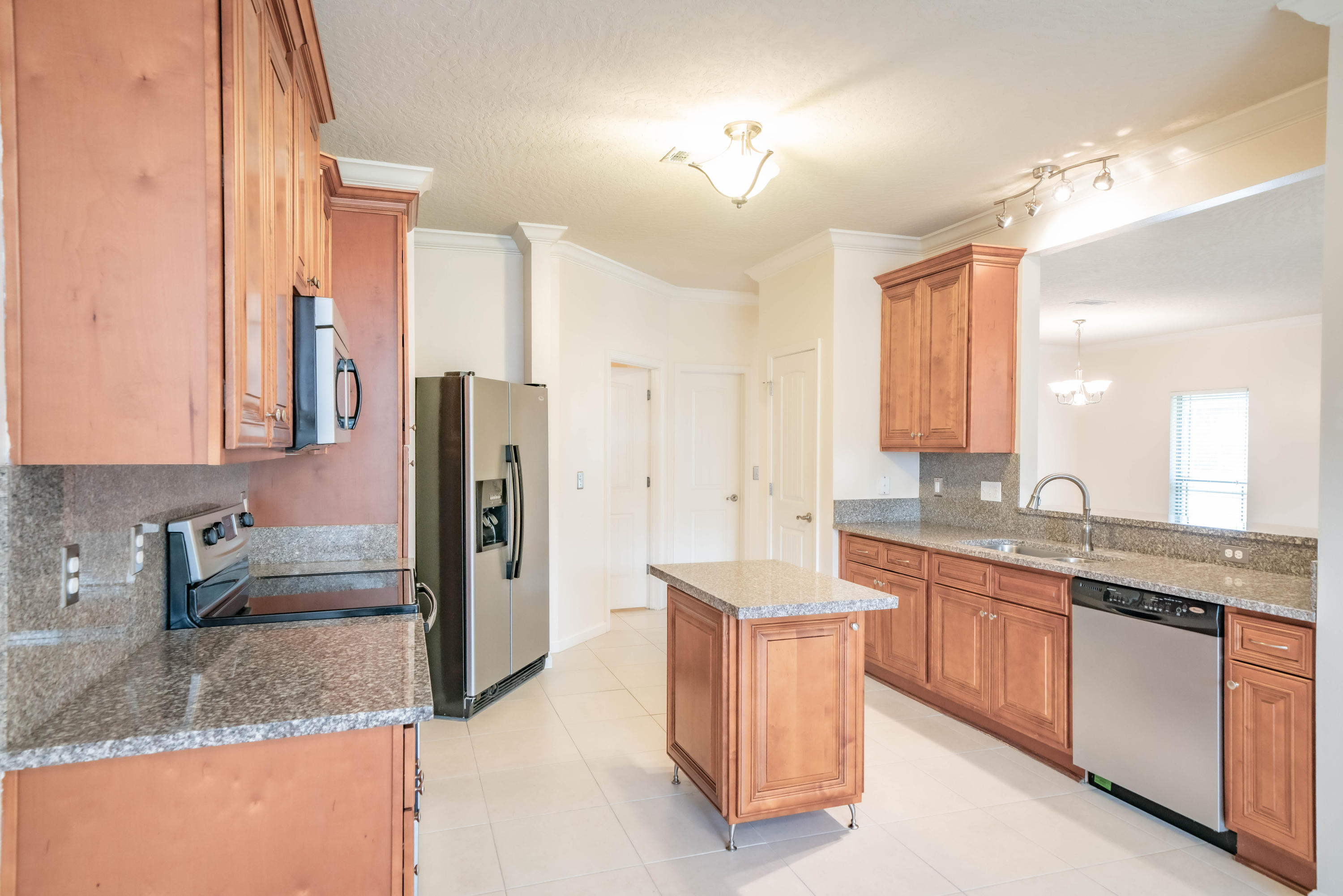 4582 Hermosa Road Crestview, FL 32539 - Photo 7 of 26 a kitchen with stainless steel appliances granite countertop a sink stove and refrigerator