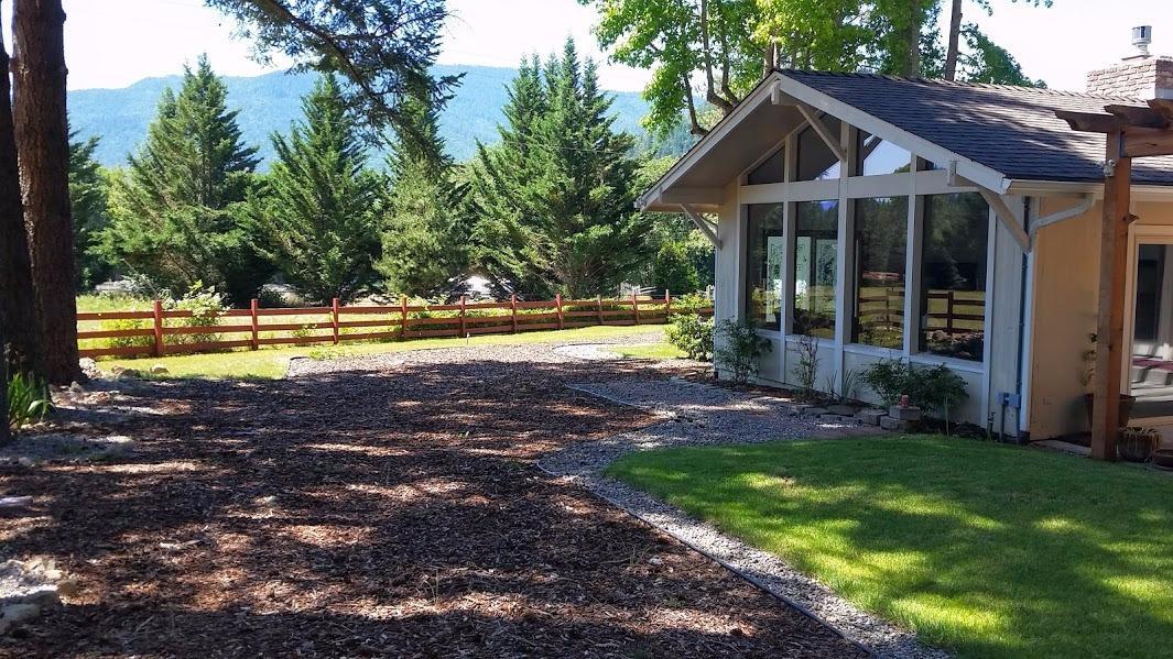 8906 North Applegate Road Grants Pass, OR 97527 - Photo 27 of 33 a front view of a house with a yard