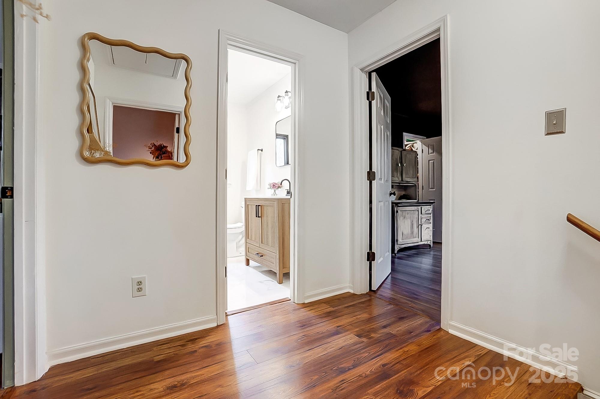 329 Treeline Drive Belmont, NC 28012 - Photo 29 of 48 a view of a hallway with wooden floor and a living room