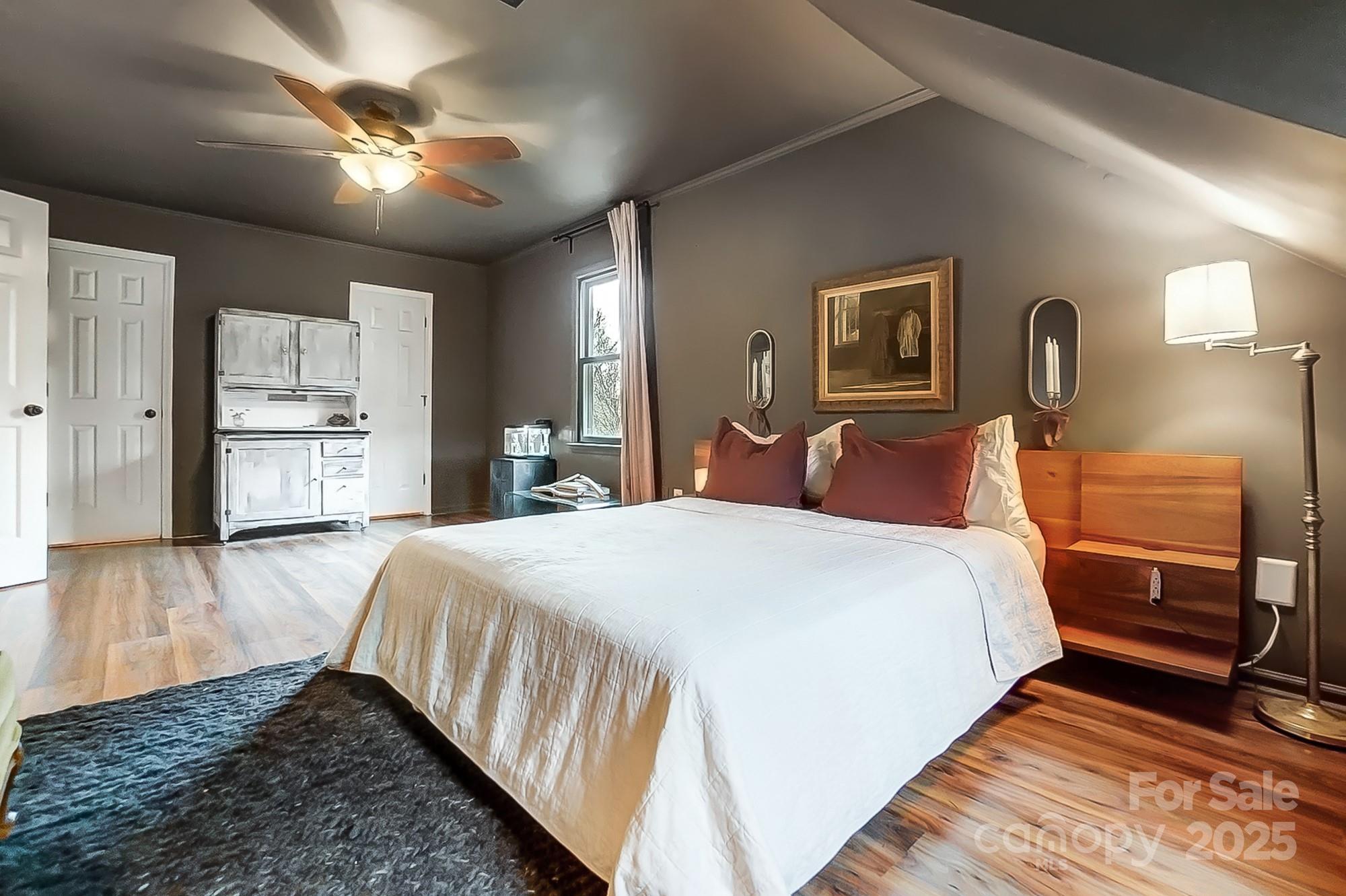 329 Treeline Drive Belmont, NC 28012 - Photo 33 of 48 a spacious bedroom with a bed and a chandelier