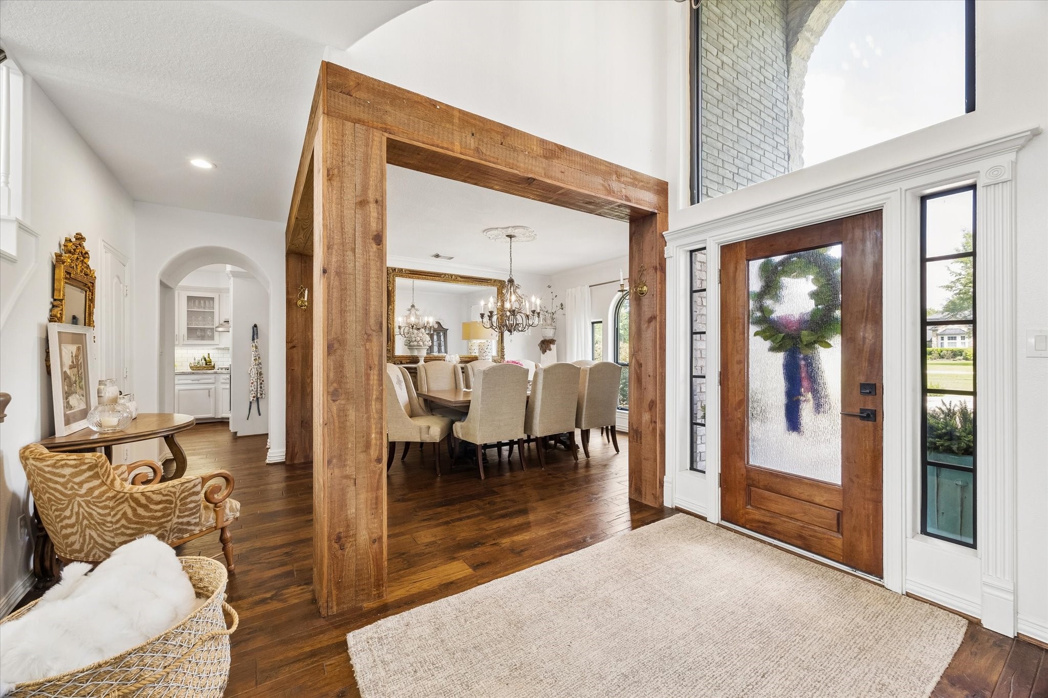 6819 Still Meadow Street Spring, TX 77389 - Photo 5 of 50 Elegant entryway leads to a spacious formal dining area adorned with a beautful chandelier and warm hardwood floors.