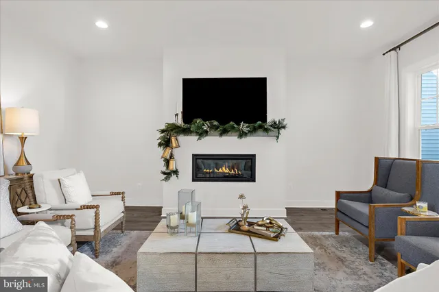 a kitchen with a sink a counter and living room view