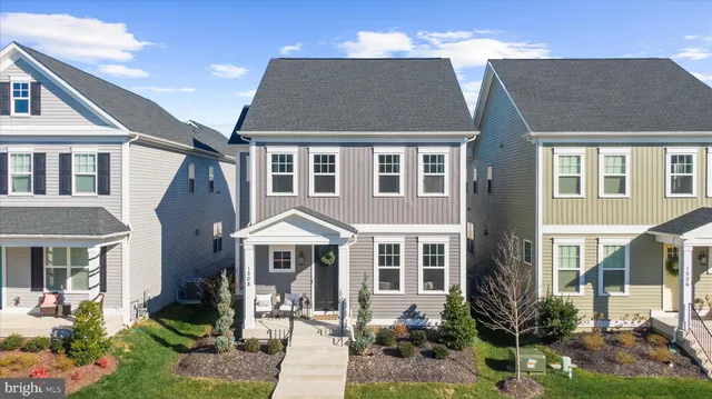 a front view of a house with a yard outdoor seating and garage
