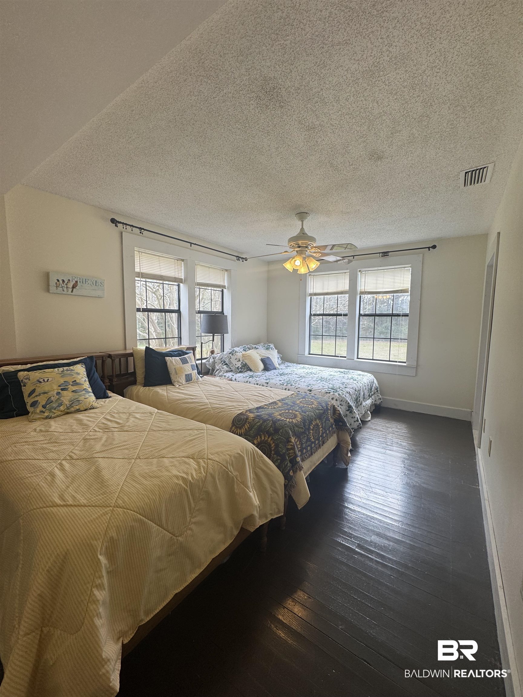 275 Thames Road Frisco City, AL 36445 - Photo 22 of 24 Bedroom with baseboards, multiple windows, visible vents, and dark wood-type flooring