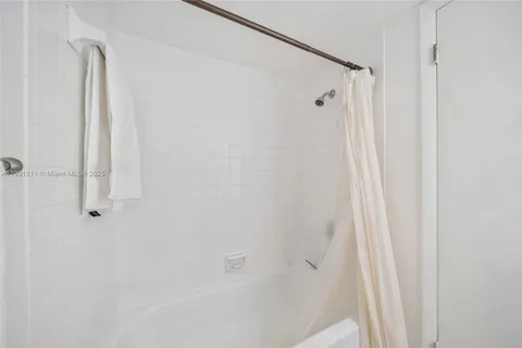 a bathroom with a shower and a tub