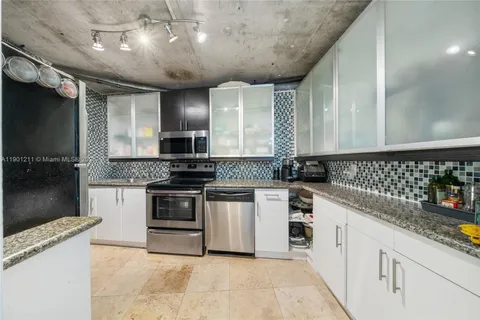 a kitchen with granite countertop a stove and a sink