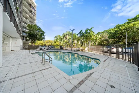 a view of swimming pool with outdoor seating and plants