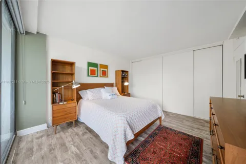 a bedroom with a bed and dresser