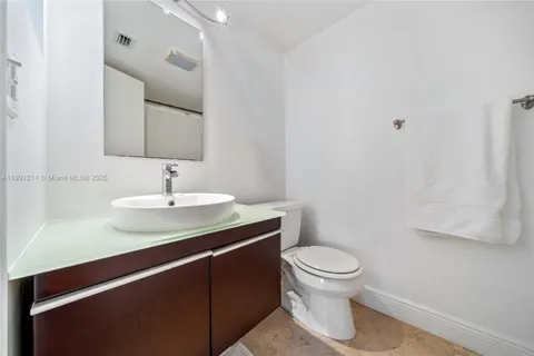 a bathroom with a sink toilet and a mirror