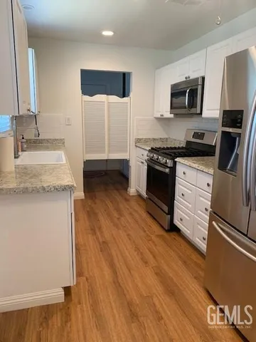 a kitchen with granite countertop a stove top oven and sink