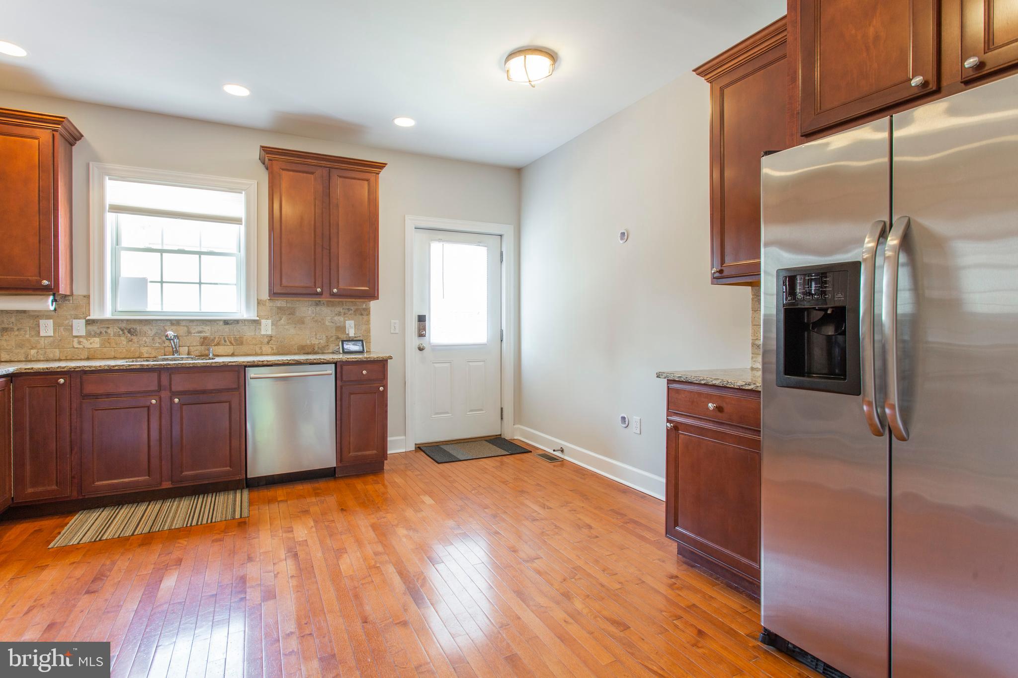 2118 Ellsworth Street Philadelphia, PA 19146 - Photo 11 of 32 a kitchen with stainless steel appliances granite countertop a refrigerator a sink and a stove
