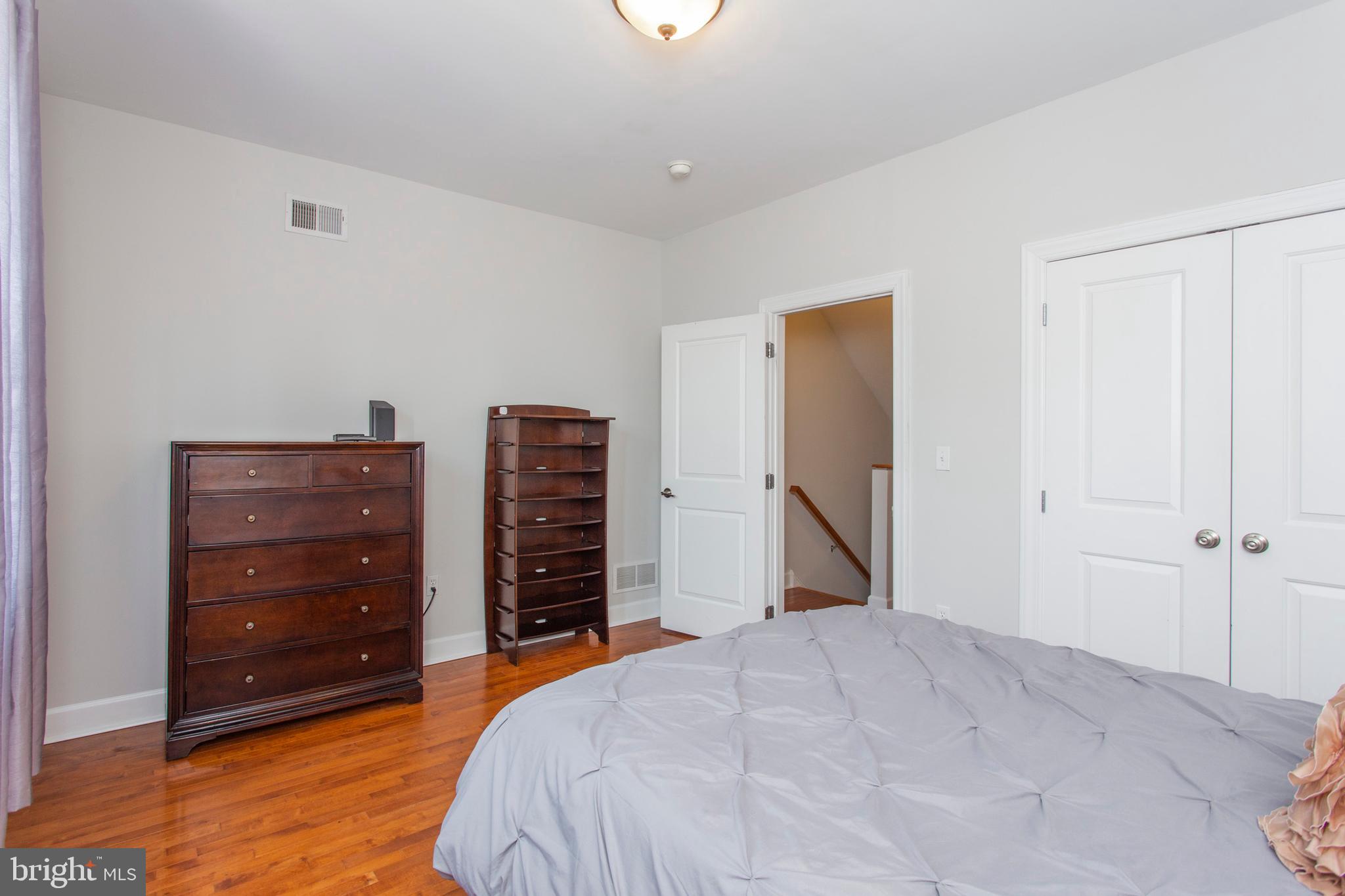 2118 Ellsworth Street Philadelphia, PA 19146 - Photo 12 of 32 a bedroom with a bed and a dresser