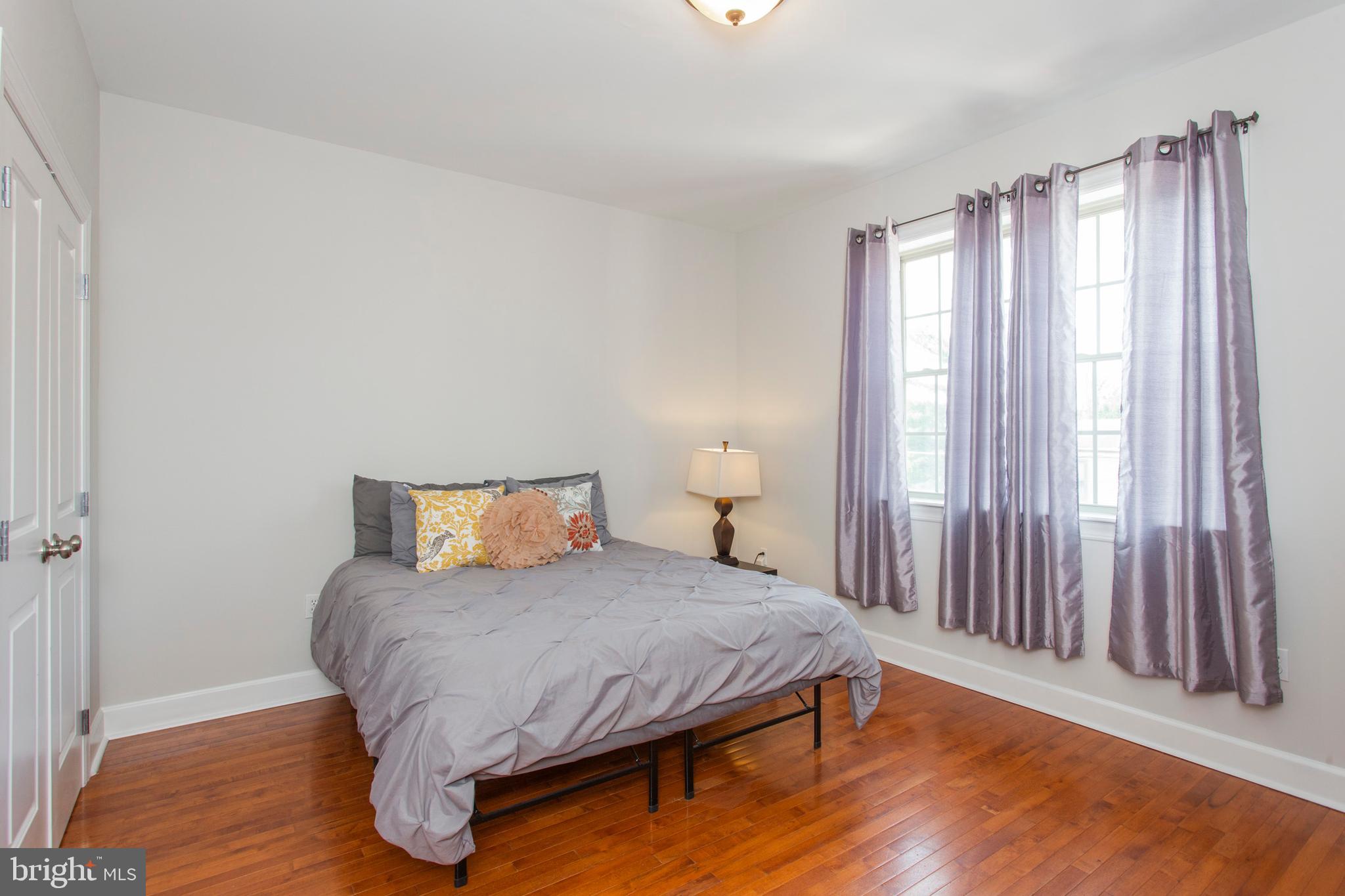 2118 Ellsworth Street Philadelphia, PA 19146 - Photo 18 of 32 a bedroom with a bed and wooden floor