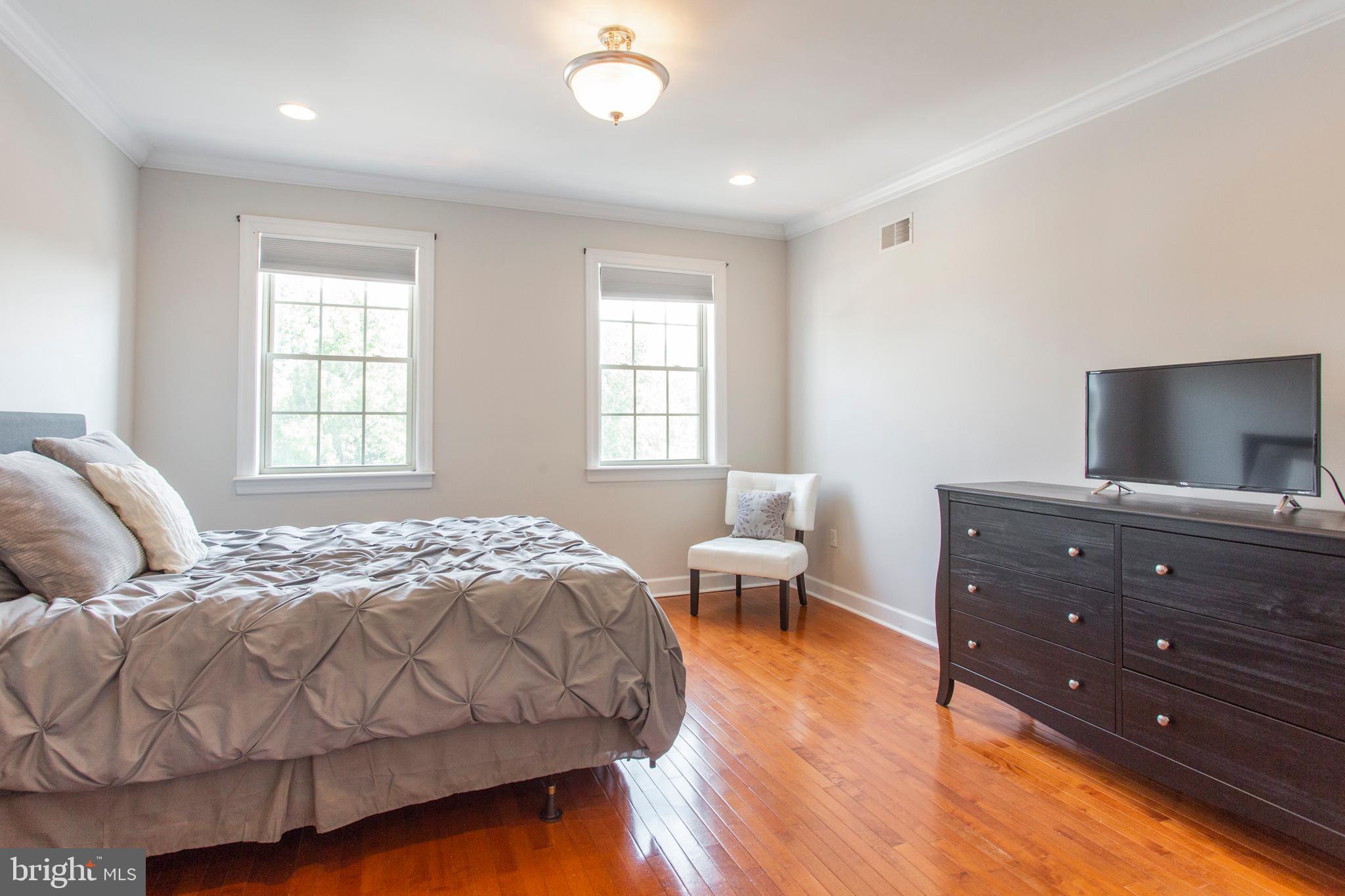 2118 Ellsworth Street Philadelphia, PA 19146 - Photo 19 of 32 a bedroom with a bed and wooden floor