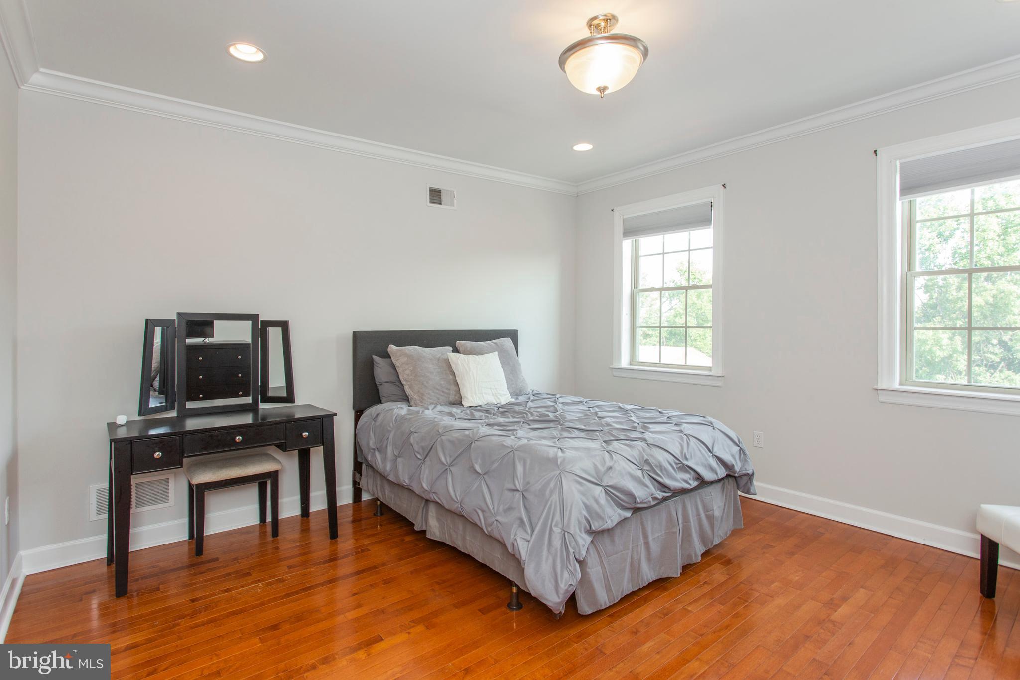 2118 Ellsworth Street Philadelphia, PA 19146 - Photo 20 of 32 a bedroom with a bed and wooden floor