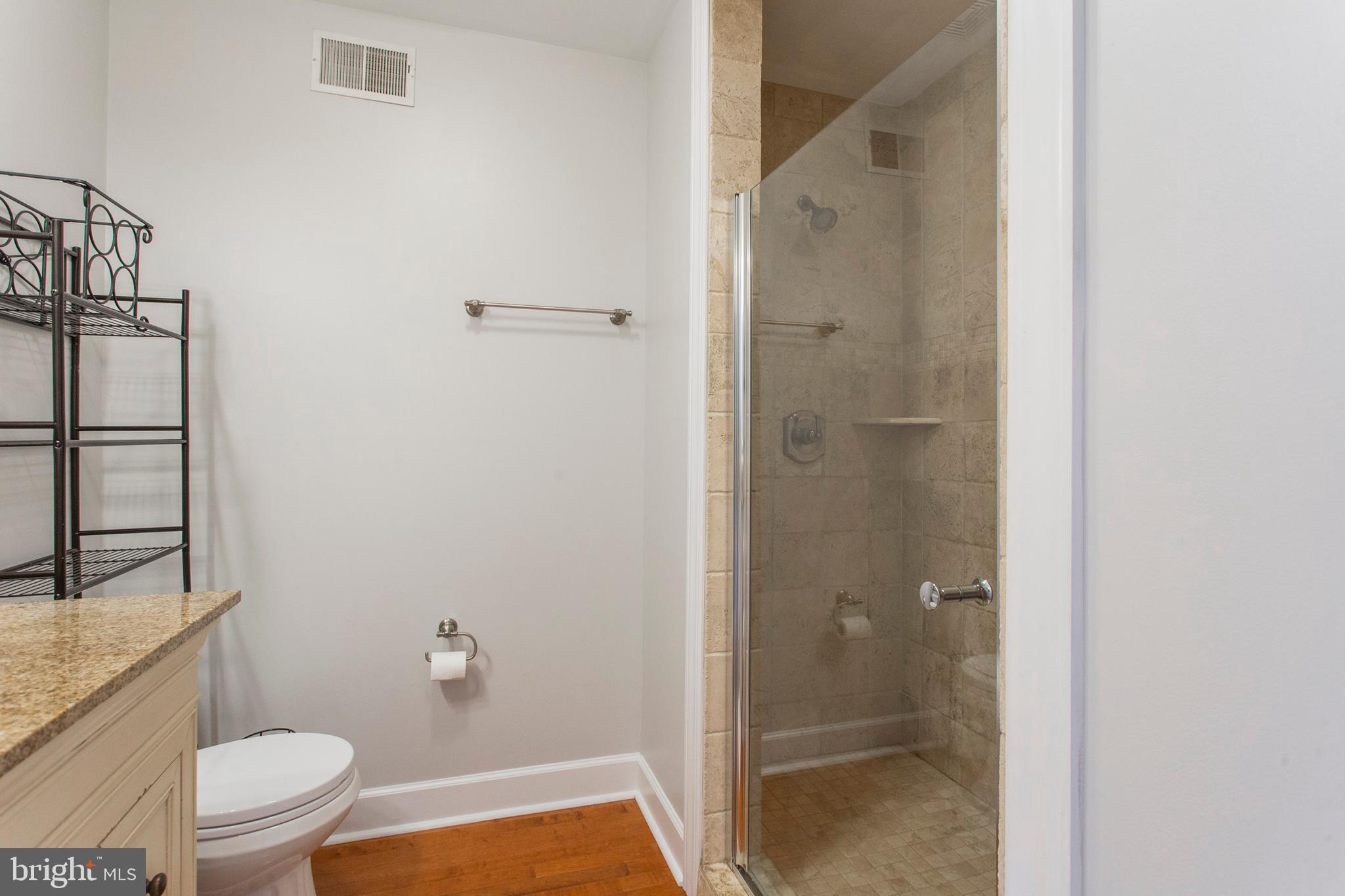 2118 Ellsworth Street Philadelphia, PA 19146 - Photo 23 of 32 a bathroom with a granite countertop bathtub shower and toilet