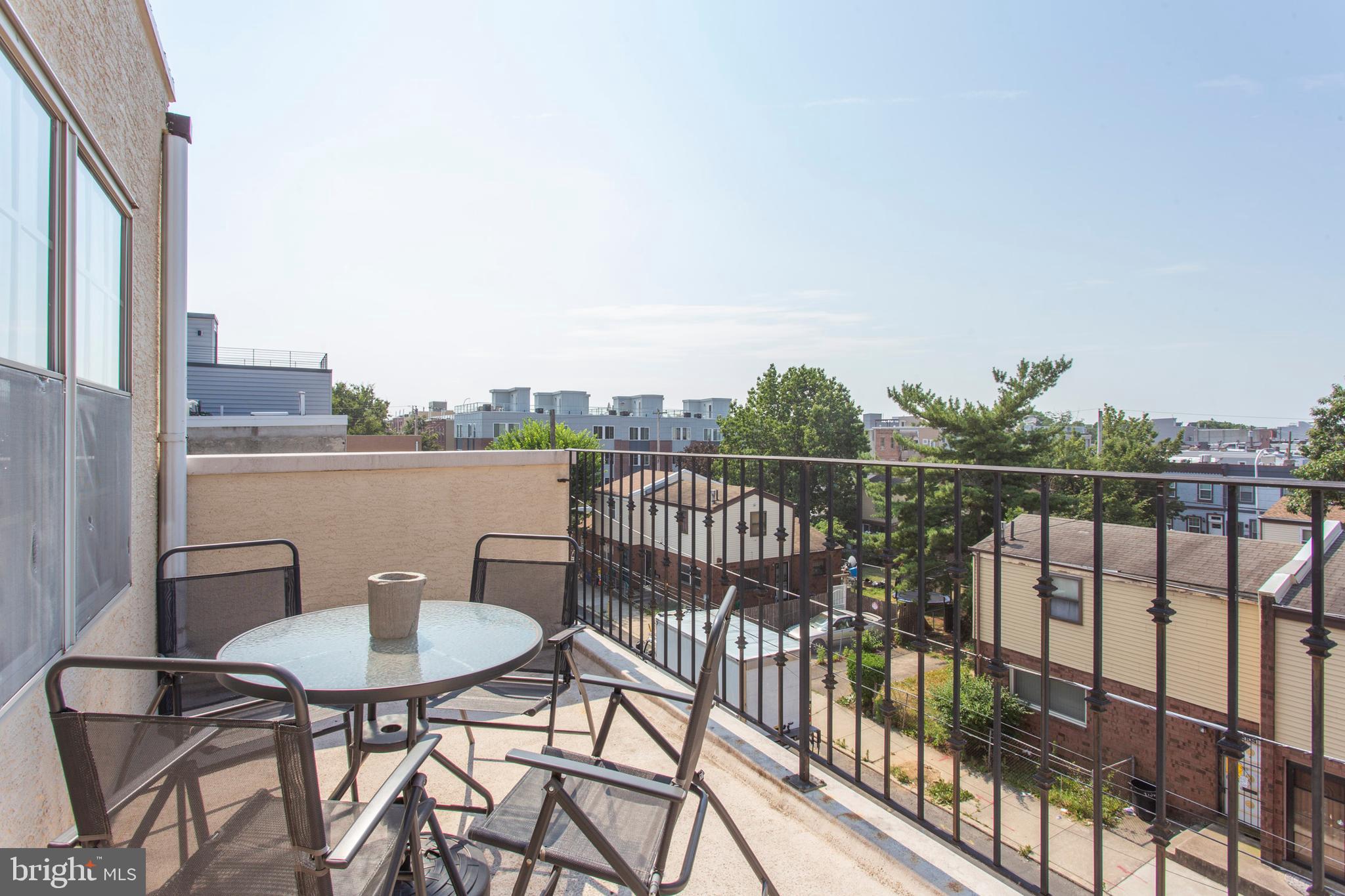 2118 Ellsworth Street Philadelphia, PA 19146 - Photo 25 of 32 a view of a balcony with wooden floor and outdoor seating