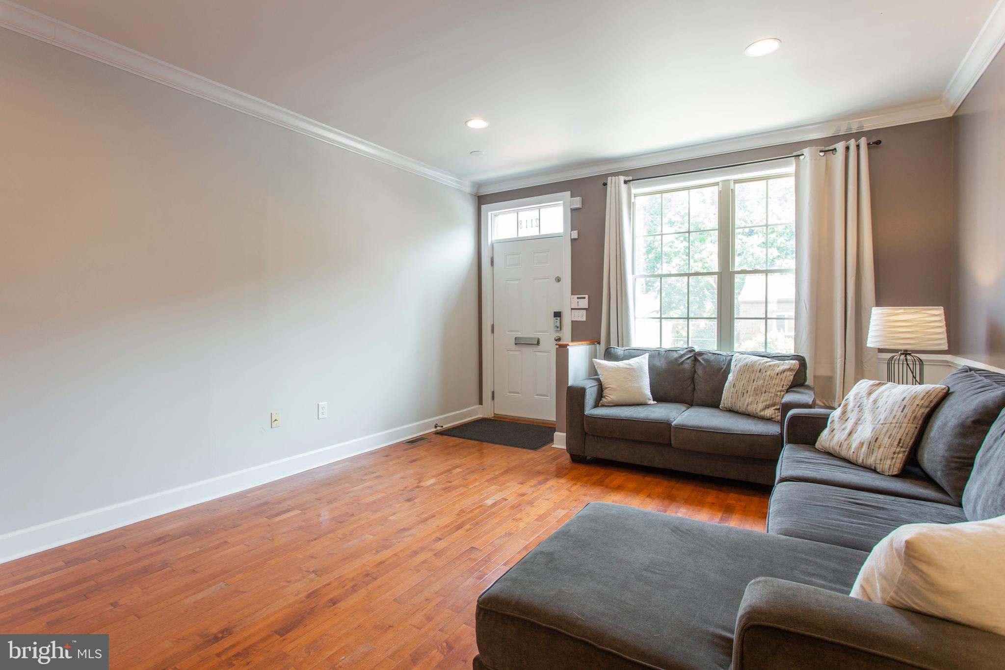 2118 Ellsworth Street Philadelphia, PA 19146 - Photo 4 of 32 a living room with furniture and a window