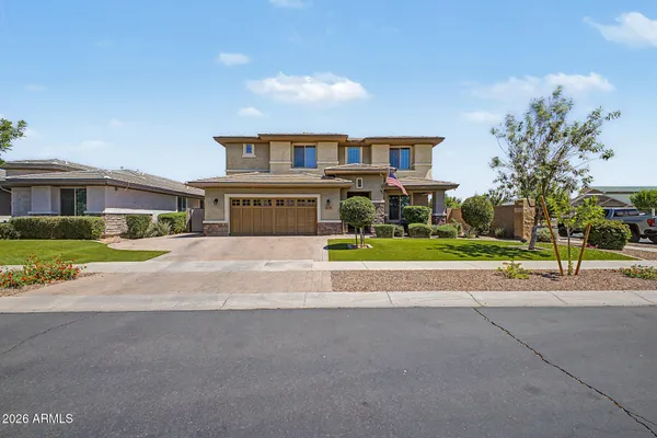 a front view of a house with a yard and garage