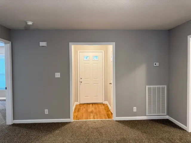 an empty room with closet and window