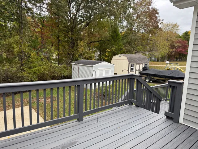 a view of a deck with wooden floor and barbeque oven