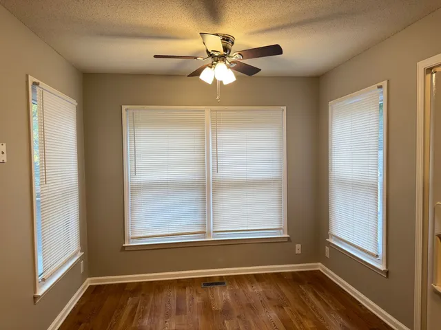 a view of wooden floor and a chandelier in a room