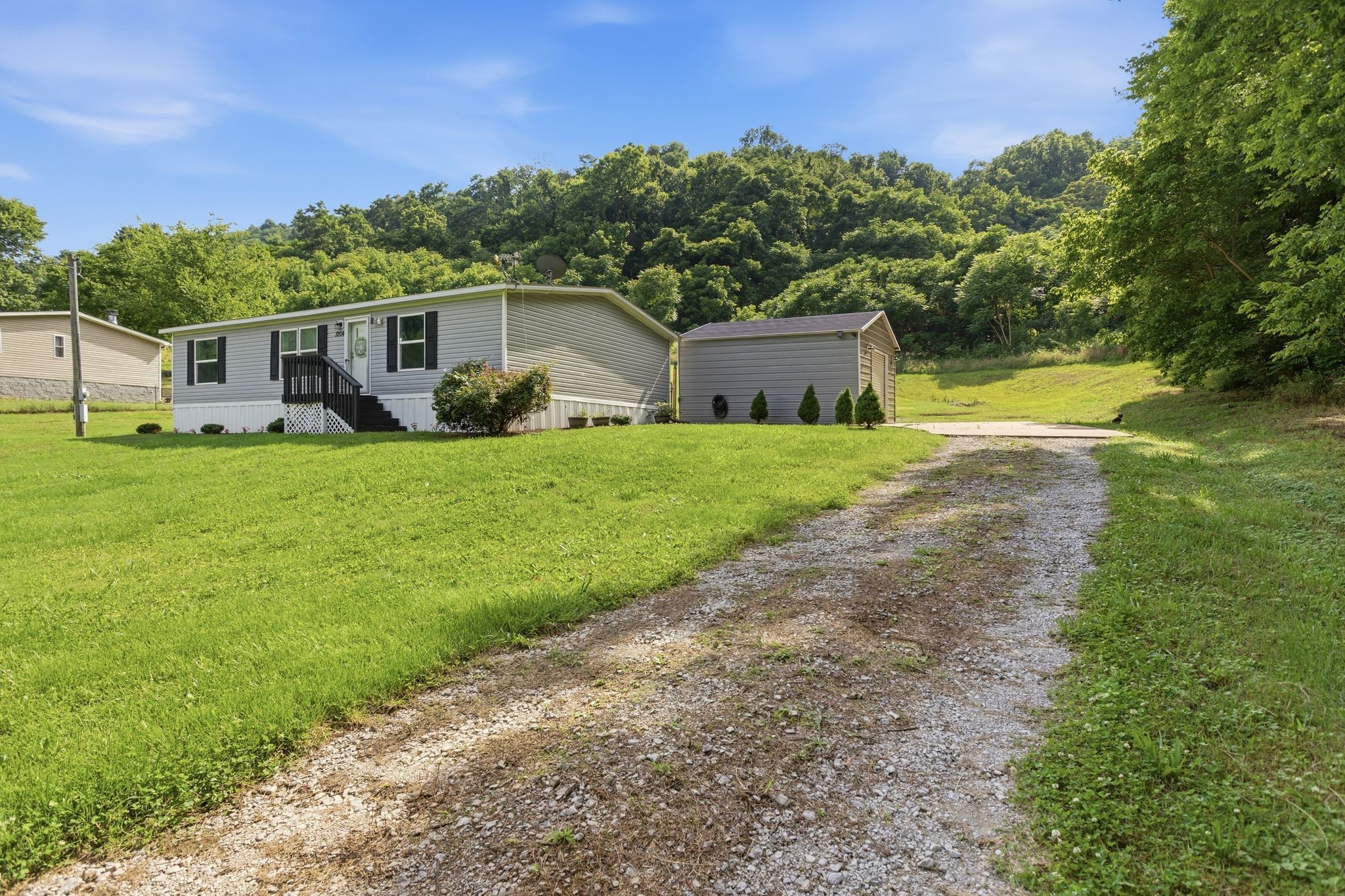 3204 Grizzly Road Culleoka, TN 38451 - Photo 3 of 25 a front view of a house with a yard and trees