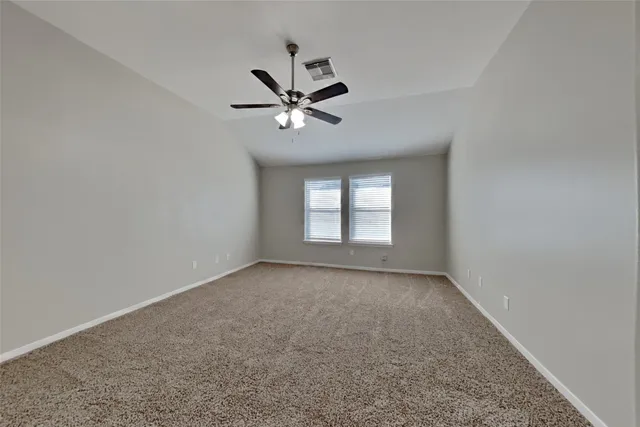 a view of room with a ceiling fan and window
