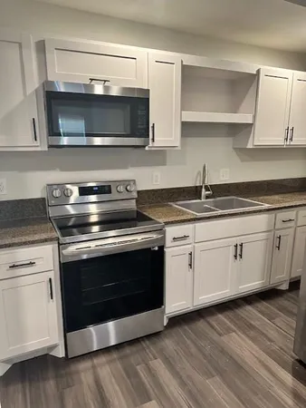 a stove top oven sitting inside of a kitchen