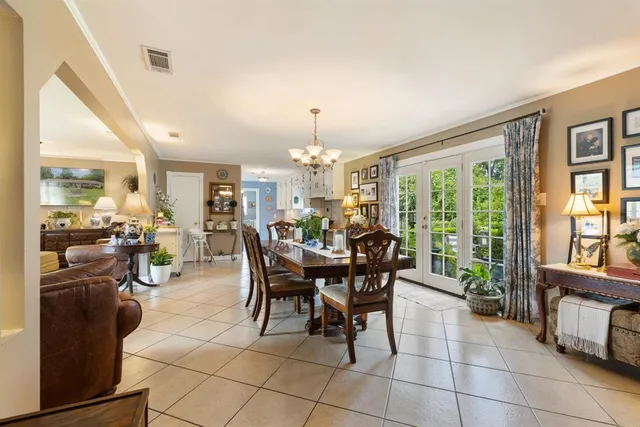 a view of a dining room with furniture and a chandelier