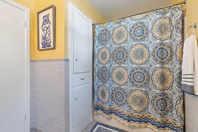 a bathroom with a window and a shower curtain