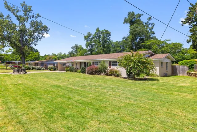 a front view of house with a garden