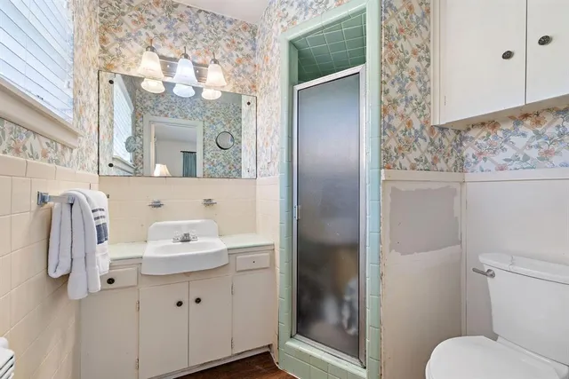 a bathroom with a sink toilet and mirror