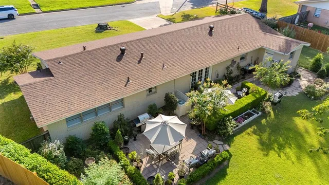 an aerial view of a house with a yard and garden