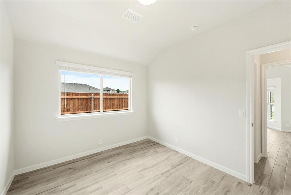 920 Elk Ridge Run Godley, TX 76044 - Photo 28 of 34 Bright interior space featuring wood-finish flooring, white baseboards, and a window with blinds