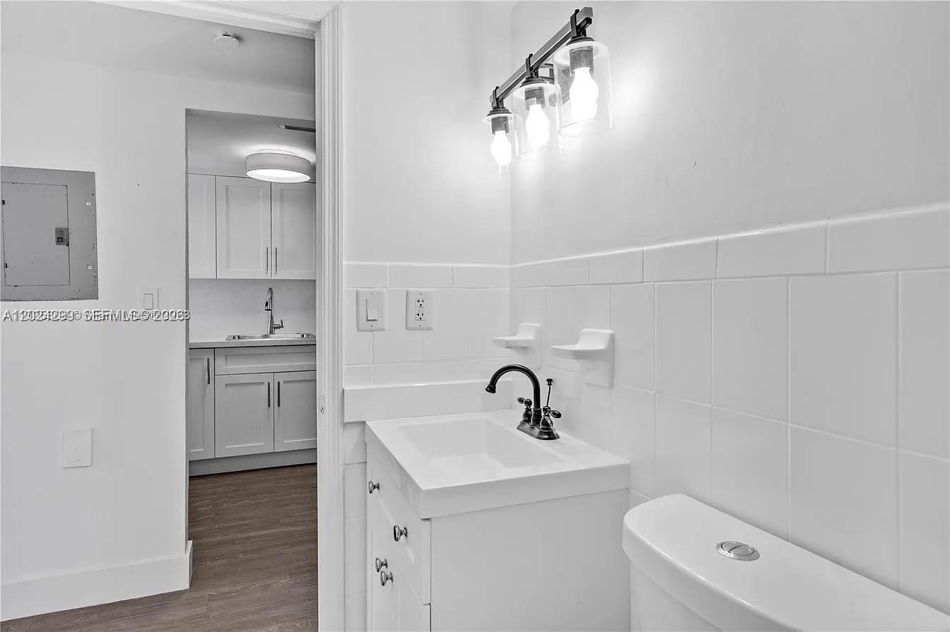 1351 Southwest 4th Street, Unit 8 Miami, FL 33135 - Photo 5 of 11 a bathroom with a sink a toilet and shower