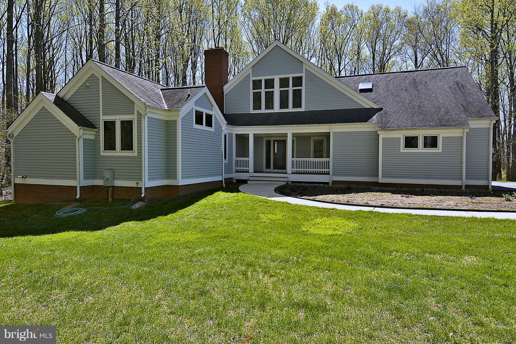 16308 Old Orchard Road Silver Spring, MD 20905 - Photo 3 of 30 a front view of a house with a yard and garage
