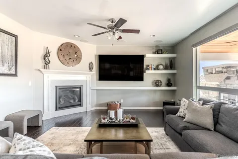 a living room with furniture a flat screen tv and a fireplace