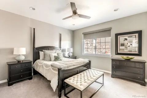 a bedroom with a bed and a dresser in it