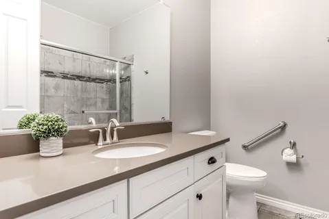 a bathroom with a sink a mirror and a toilet