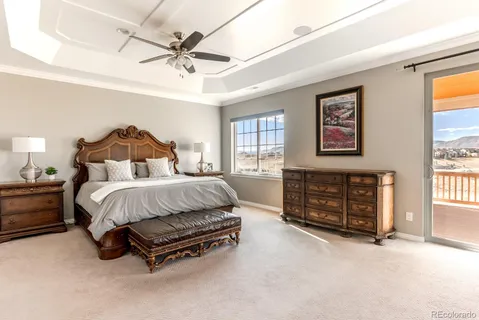 a bedroom with a bed dresser and window