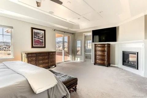 a spacious bedroom with a bed and a television