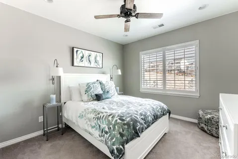 a bedroom with a bed and painting on the wall