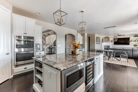 a kitchen with stainless steel appliances granite countertop a stove and cabinets
