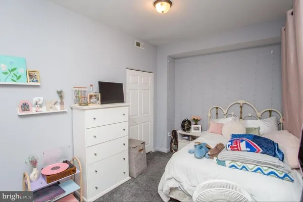 a bedroom with a bed and flat screen tv