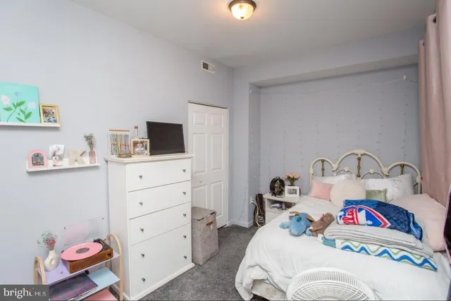 a bedroom with a bed and flat screen tv