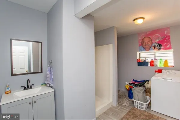 a view of storage utility and utility room with racks on the wall