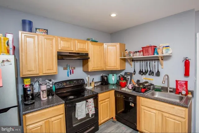a kitchen with granite countertop a stove and cabinets