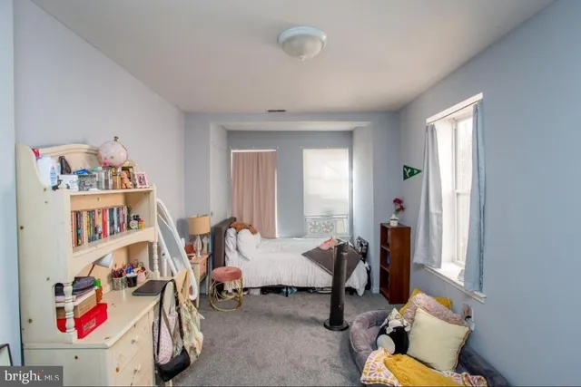 a bedroom with furniture and a book shelf